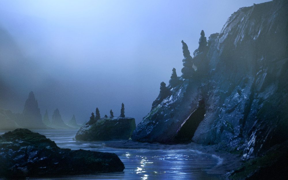 Stop-motion coastline with dark cliffs and rocks in blue mist